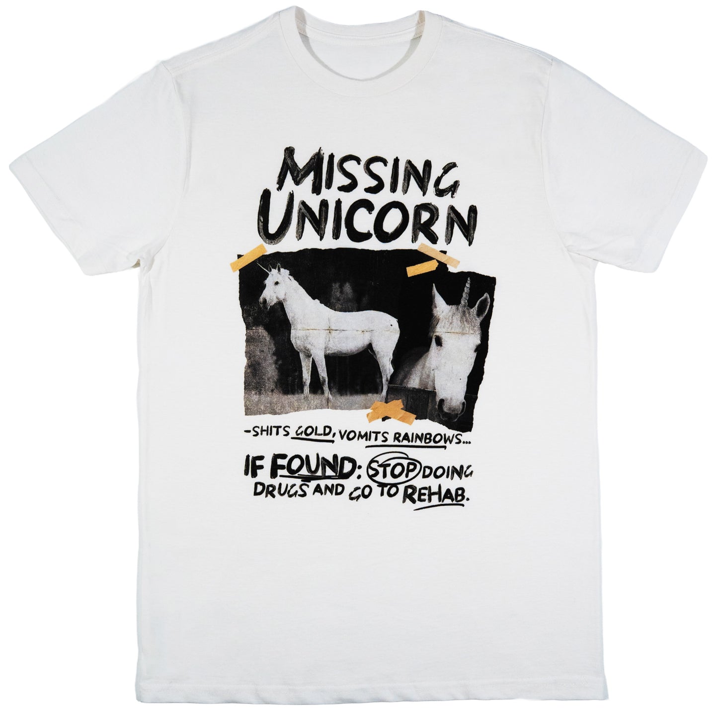A white short-sleeve crewneck t-shirt featuring a humorous graphic print of two white horses with horns, styled like a 'Missing Unicorn' flyer with text that reads 'IF FOUND: STOP DOING DRUGS AND GO TO REHAB.'.