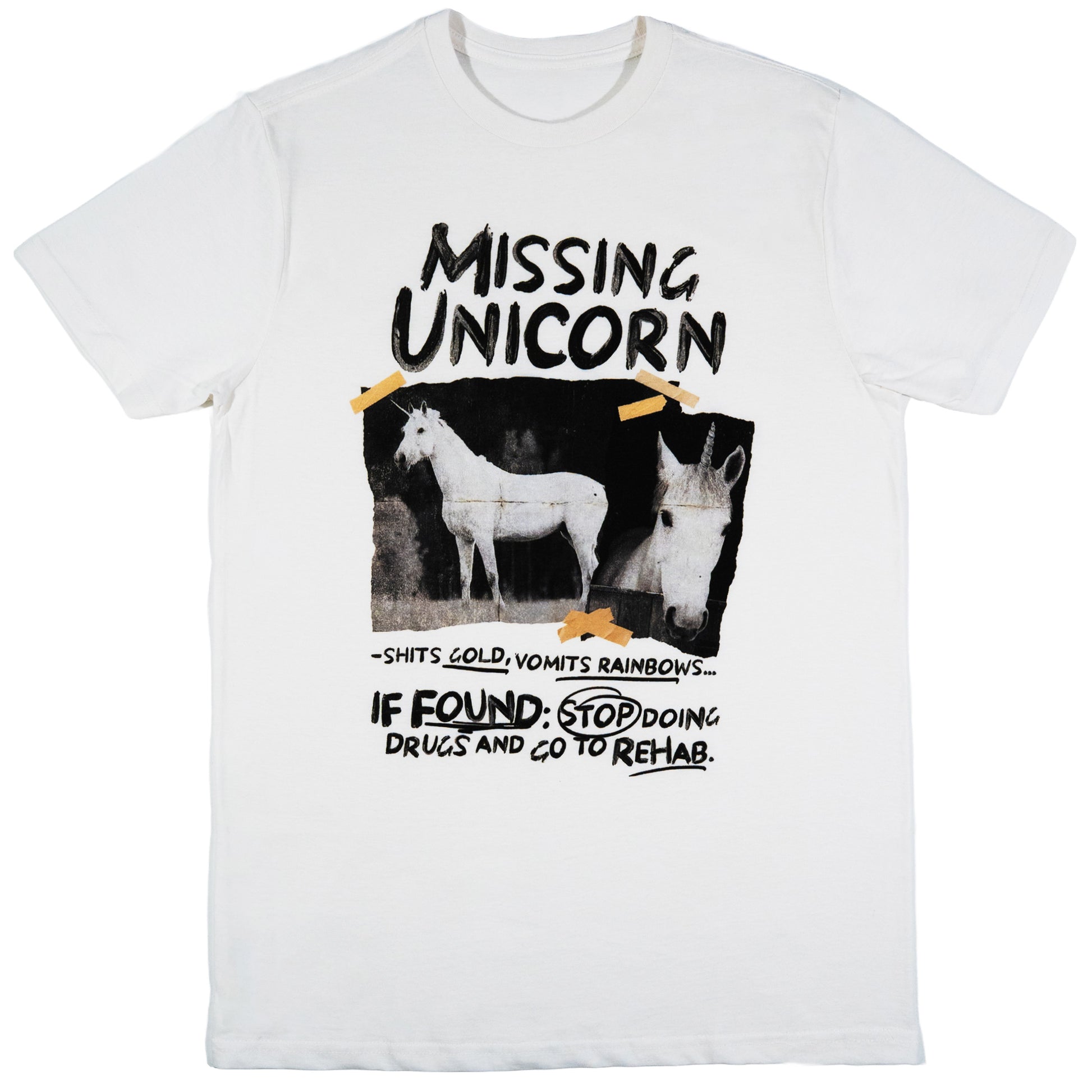 A white short-sleeve crewneck t-shirt featuring a humorous graphic print of two white horses with horns, styled like a 'Missing Unicorn' flyer with text that reads 'IF FOUND: STOP DOING DRUGS AND GO TO REHAB.'.