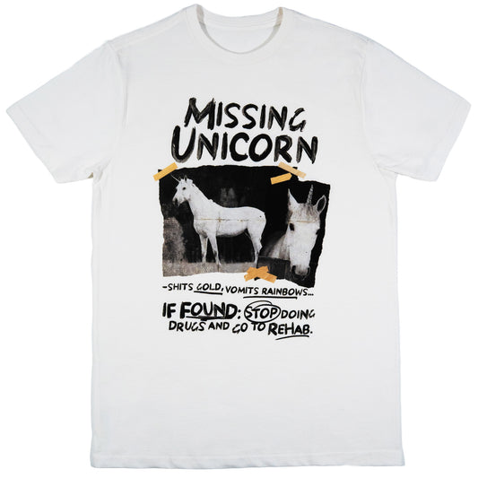 A white short-sleeve crewneck t-shirt featuring a humorous graphic print of two white horses with horns, styled like a 'Missing Unicorn' flyer with text that reads 'IF FOUND: STOP DOING DRUGS AND GO TO REHAB.'.